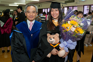 A BBA graduate took a photo with Professor Raymond So, Dean of School of Business after the Graduation Ceremony.