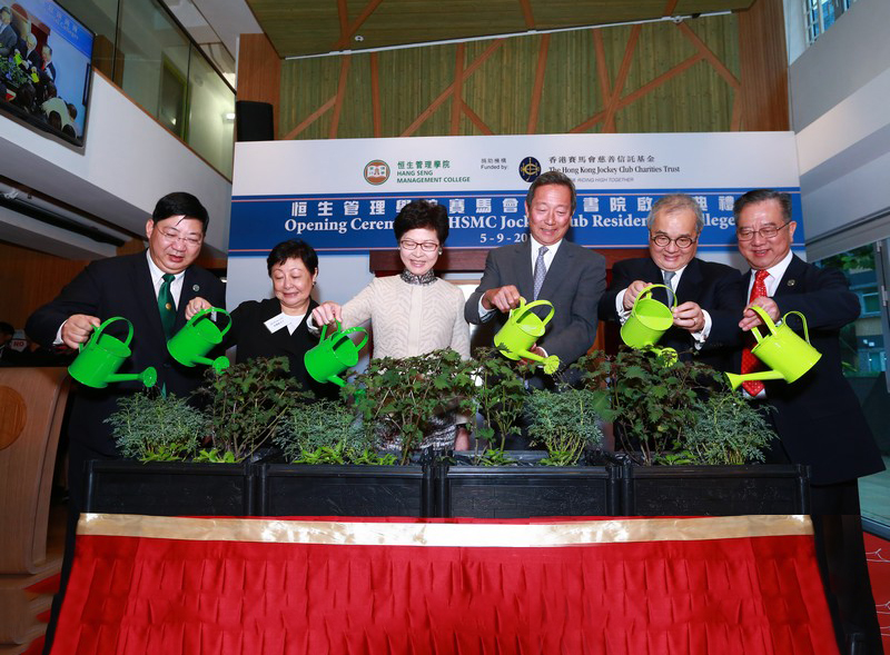 Officiating guests proceeding plant watering, signifying the support of students’ growth