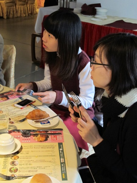 Professors and students paying high attention to learning table manners