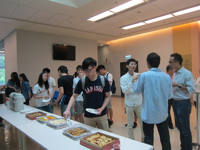 Students and staff networking with Samuel and Sunny after the talk