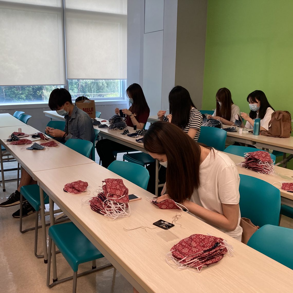 Students are conducting the quality control practices for the hand-made face masks