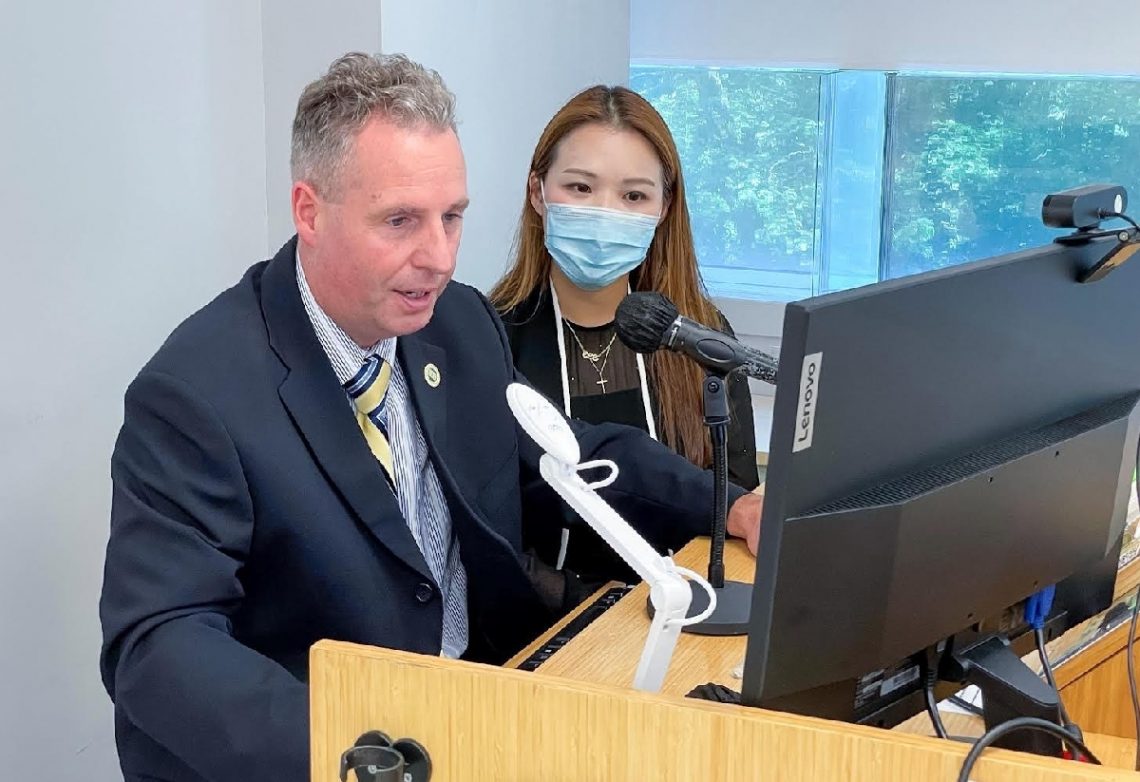 Professor Bradley R Barnes, Dean of School of Business, and Ms Elaine Shiu, an alumna of the School, welcome and greet new students through screen.