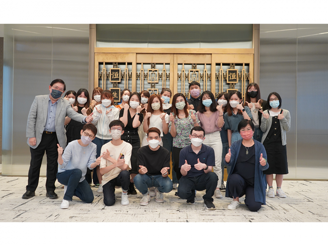 Group Photo of SCOM teachers and students in front of the bronze gate at the Penthouse.