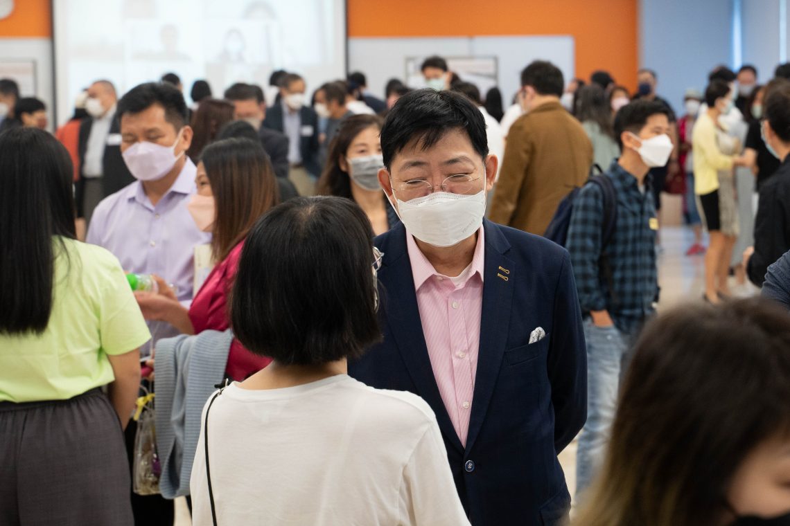 President Simon Ho interacts with parent.