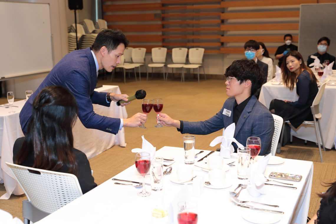 Mr So demonstrates how to elegantly clink a wine glass - from proper positioning to the right sound.