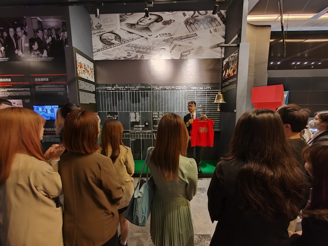 HKEX staff introduces the red vest previously worn by Hong Kong Stock Exchange traders.